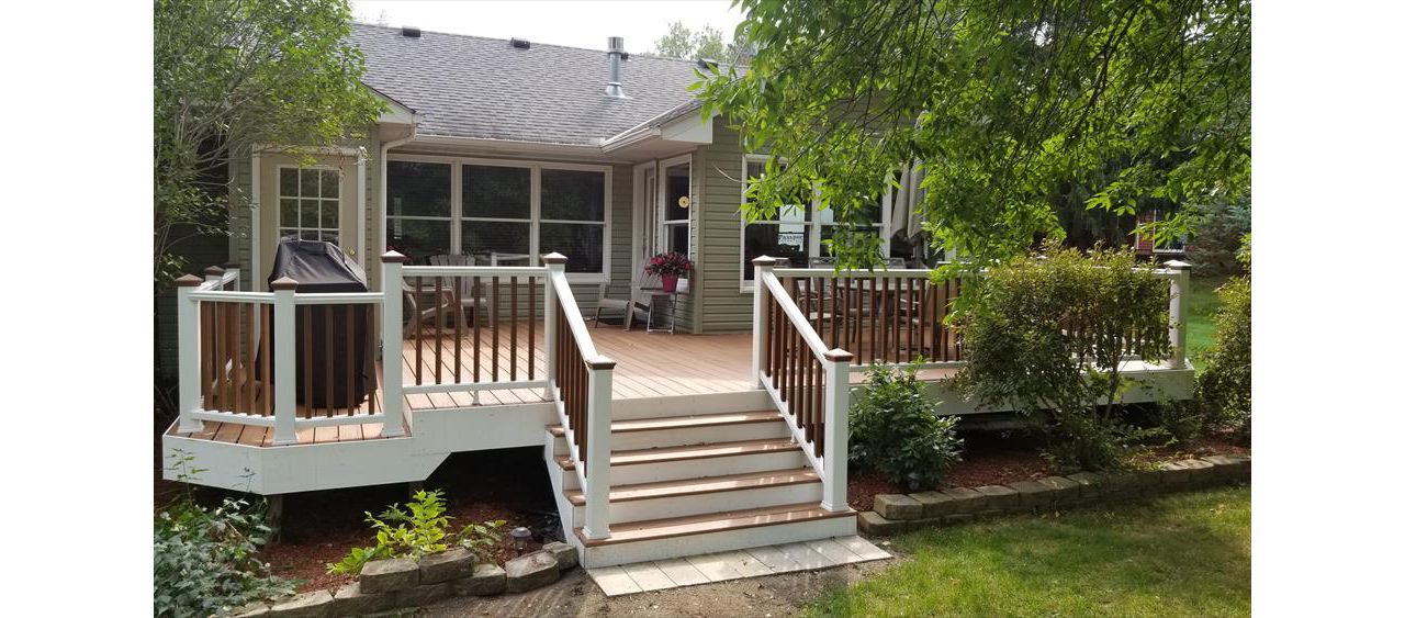 Trex Transcend Tropics Tiki Torch deck boards with Transcend crown railing (classic white rails with tree house balusters), Classic white fascia serving the Twin Cites, Hastings, Woodbury, Egan, Edina, Minneapolis, Lake of the Isles