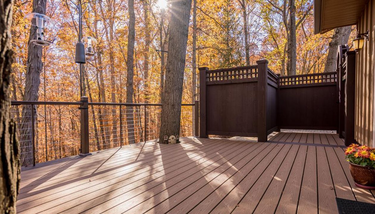 Brecksville Trex Enhance Beach Dune Deck with Vintage Lantern boarder. Custom aluminum cable rail system with under rail lighting.