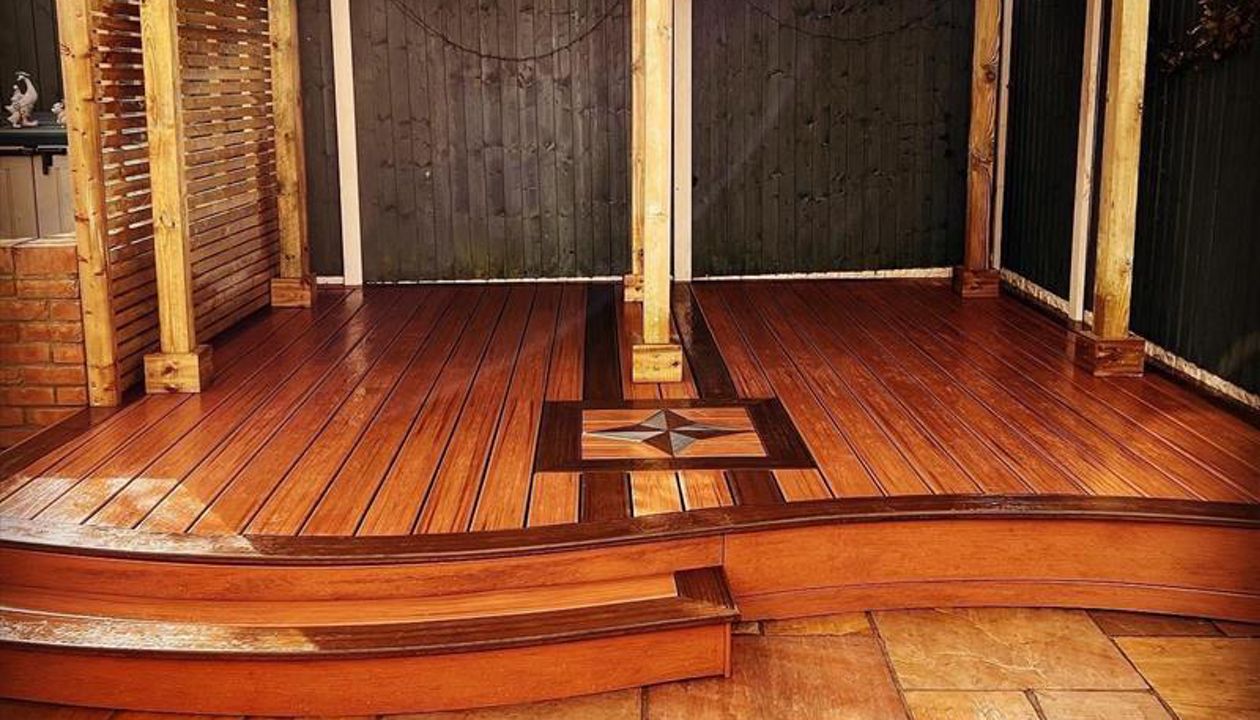 Trex Transcend Tiki Torch field with Spiced rum boarder with Star inlay and roofed Pergola fitted at Swansea