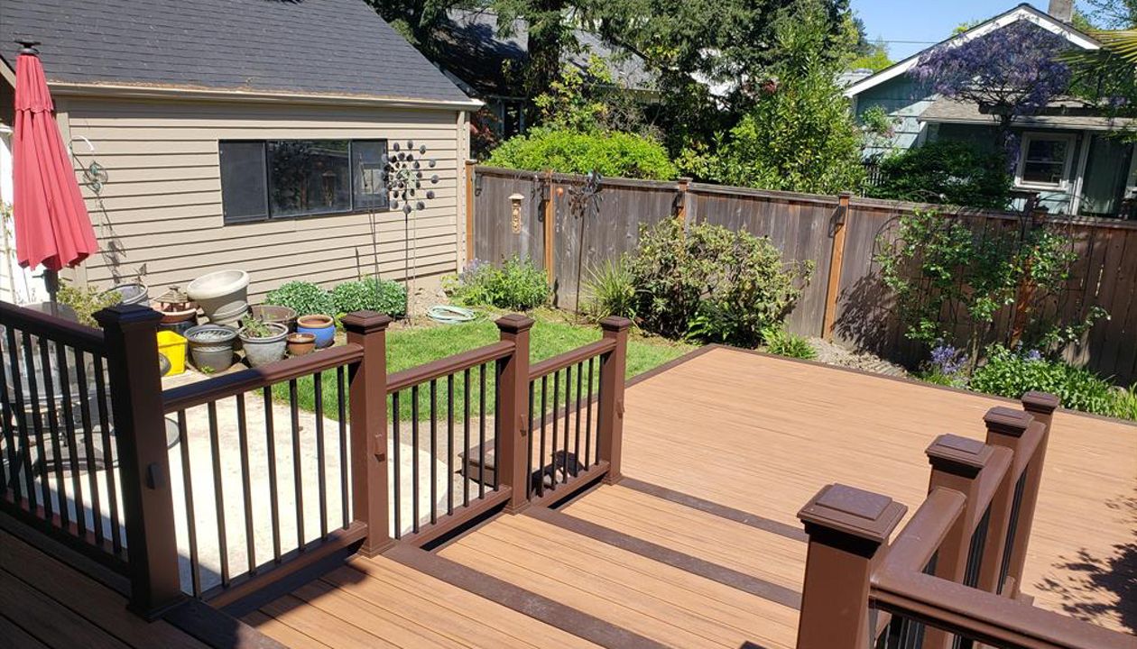 Trex Transcend Tiki Torch decking with Vintage Lantern boarder, Transcend Vintage Lantern railing with metal balusters and Trex lighting