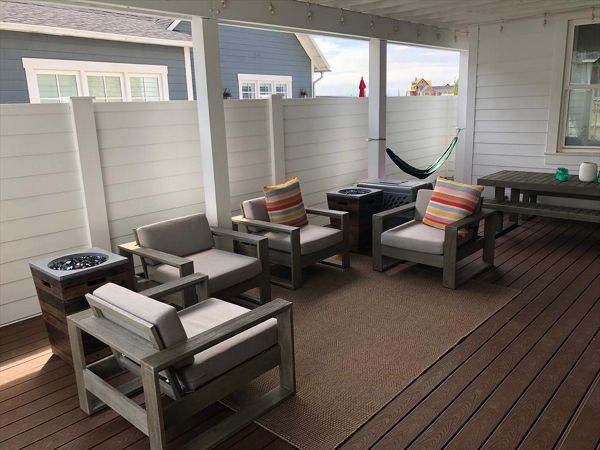 This home we took out the railings and added 6' privacy and wind fences. added a metal roof on the trellis and now this area is the favorite place to be.