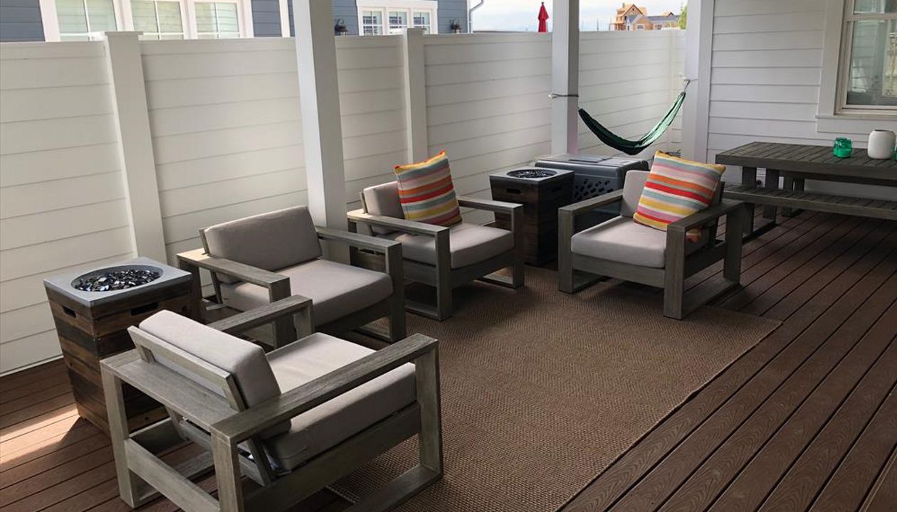 This home we took out the railings and added 6' privacy and wind fences. added a metal roof on the trellis and now this area is the favorite place to be.