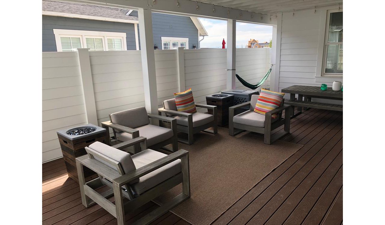 This home we took out the railings and added 6' privacy and wind fences. added a metal roof on the trellis and now this area is the favorite place to be.