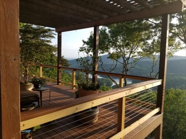 North Georgia Elite Decks Installed Saddle for decking boarder and the Cocktail Rails and used Beach Dune for the decking.