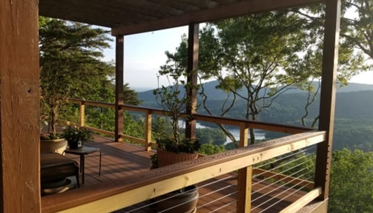 North Georgia Elite Decks Installed Saddle for decking boarder and the Cocktail Rails and used Beach Dune for the decking.