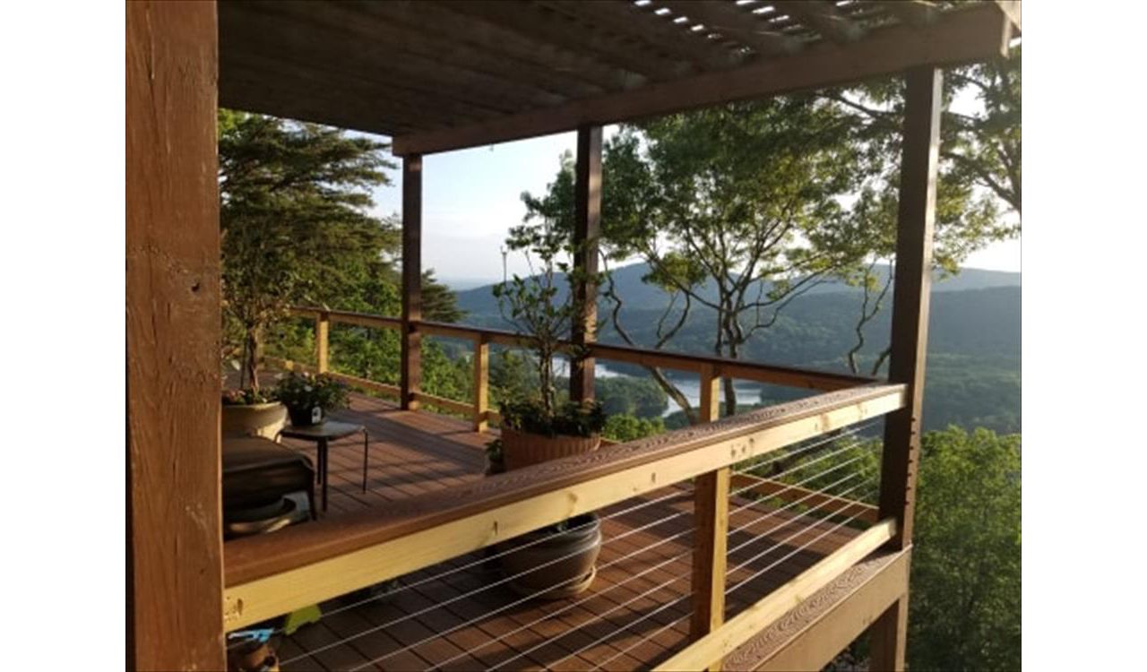 North Georgia Elite Decks Installed Saddle for decking boarder and the Cocktail Rails and used Beach Dune for the decking.