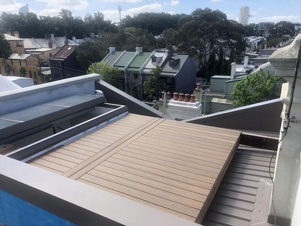 Trex Havana gold roof top deck with removable boards for access to the box gutter.