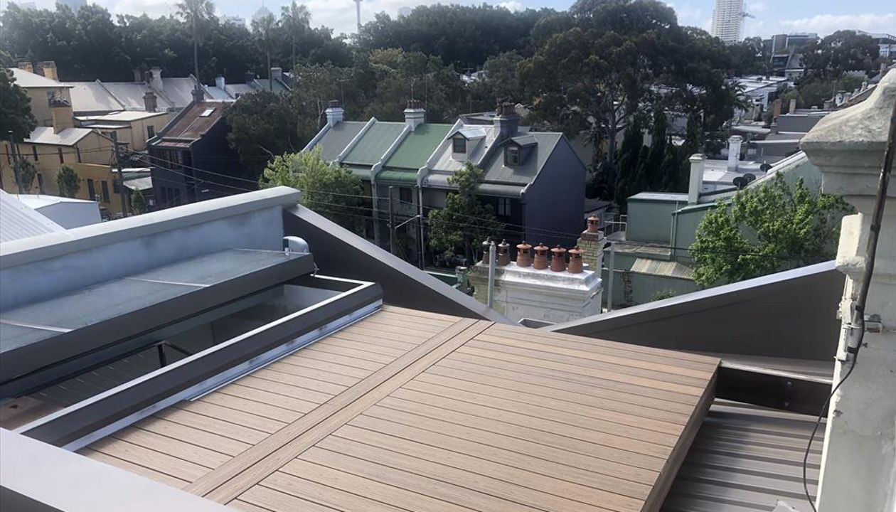 Trex Havana gold roof top deck with removable boards for access to the box gutter.