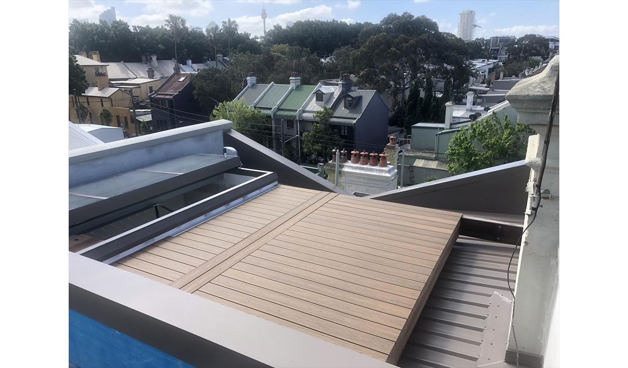 Trex Havana gold roof top deck with removable boards for access to the box gutter.