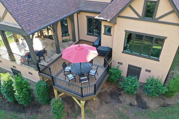 A great deck addition to the back of this home with two composite colors to accent the dining area of this deck.