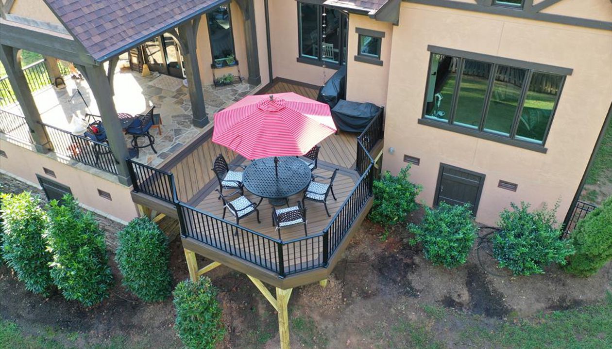 A great deck addition to the back of this home with two composite colors to accent the dining area of this deck.