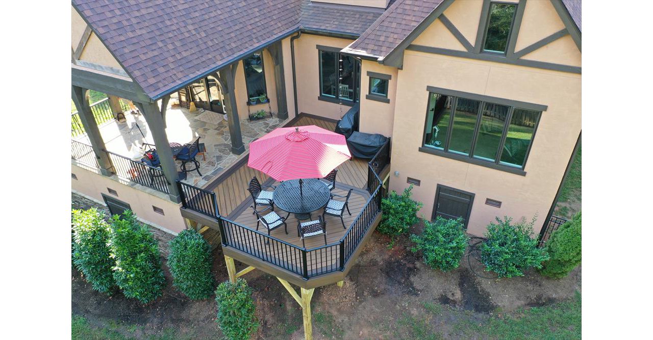 A great deck addition to the back of this home with two composite colors to accent the dining area of this deck.