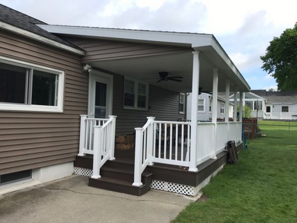 4 of 4 - 10x24 covered deck with Spiced Rum Trex Transcend with all hidden fasteners with RDI vinyl railing system with white balusters.