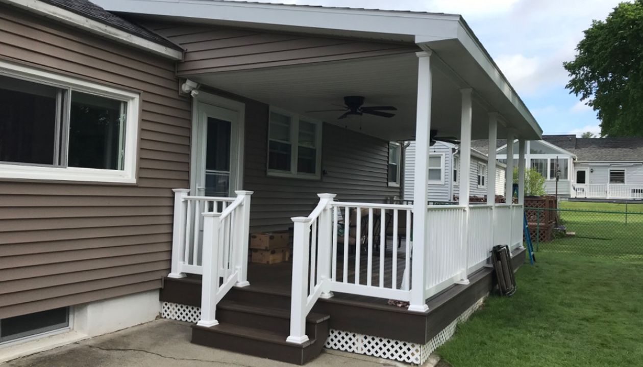 4 of 4 - 10x24 covered deck with Spiced Rum Trex Transcend with all hidden fasteners with RDI vinyl railing system with white balusters.