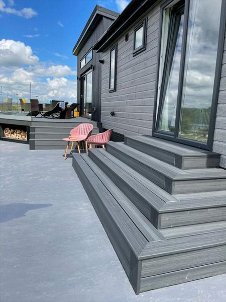 TREX Enhance Naturals Calm Water Decking with bespoke log store and contemporary style slatted skirting around the base completed in Harrogate