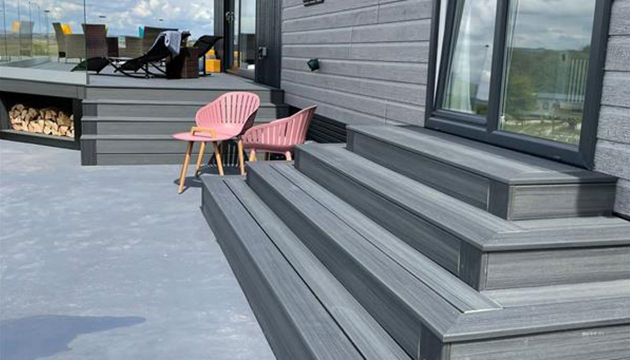 TREX Enhance Naturals Calm Water Decking with bespoke log store and contemporary style slatted skirting around the base completed in Harrogate