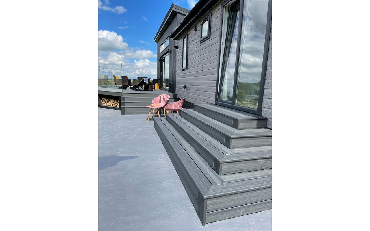 TREX Enhance Naturals Calm Water Decking with bespoke log store and contemporary style slatted skirting around the base completed in Harrogate