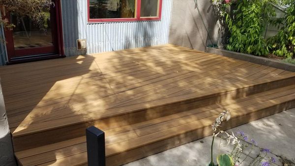 Trex Transcend Havana Gold Deck, Big Sky, MT. Backyard deck, (approx. 16' x 12') with 15 degree angle to single full length step.