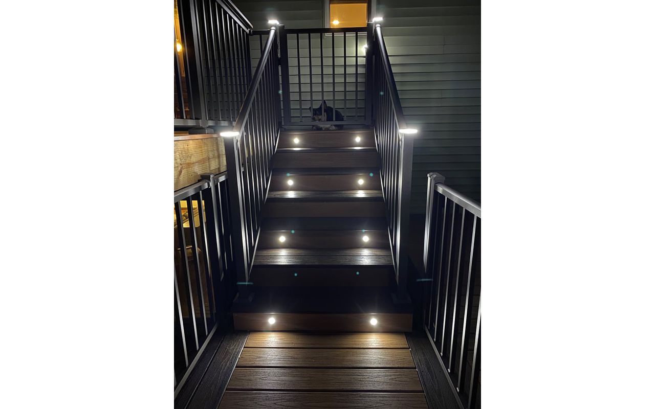 Two-Tone Low-Maintenance Trex Transcend Composite Deck Stairway with Aluminum Railing & Gate and Super Cool LED Lighting for Safety and Ambiance in the Rochester, MN Area built by Schmidt Carpentry, LLC