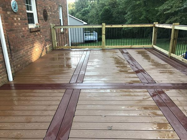 Trex Select Saddle decking with Madeira feature boards looks great on this brick home