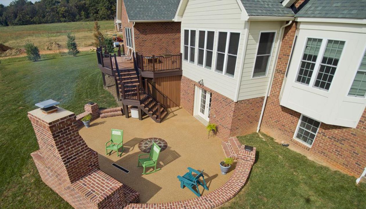 Trex Transcends decking with Signature Rail -Exposed aggregate patio with outdoor fireplace
