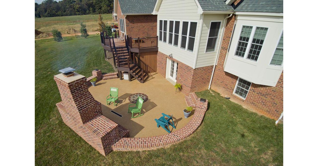 Trex Transcends decking with Signature Rail -Exposed aggregate patio with outdoor fireplace