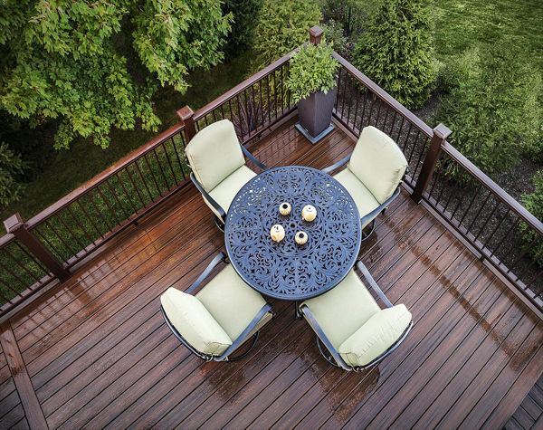 In Flemington, N.J., this delightful deck features Trex Transcend posts and top and bottom rails in Vintage Lantern, accented with round bronze balusters.