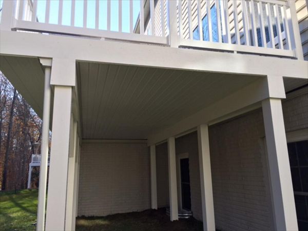 Trex RainEscape System with a closed off soffit ceiling and PVC wrapped posts and beams.