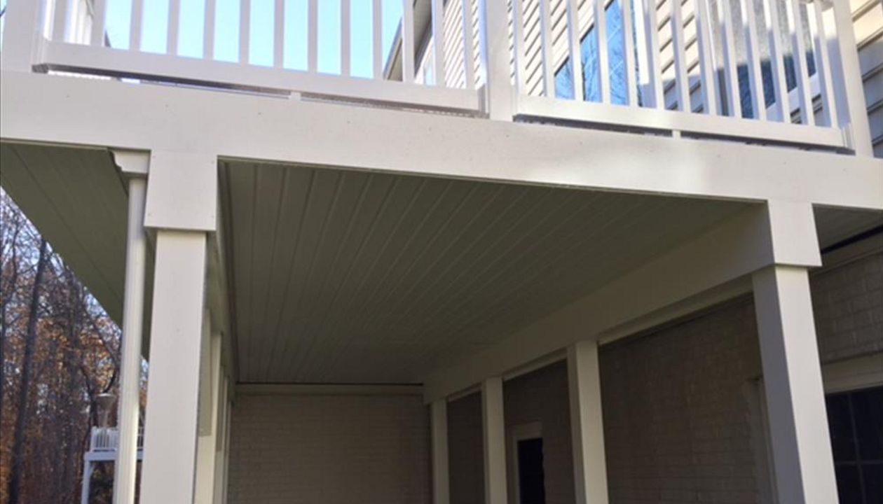 Trex RainEscape System with a closed off soffit ceiling and PVC wrapped posts and beams.