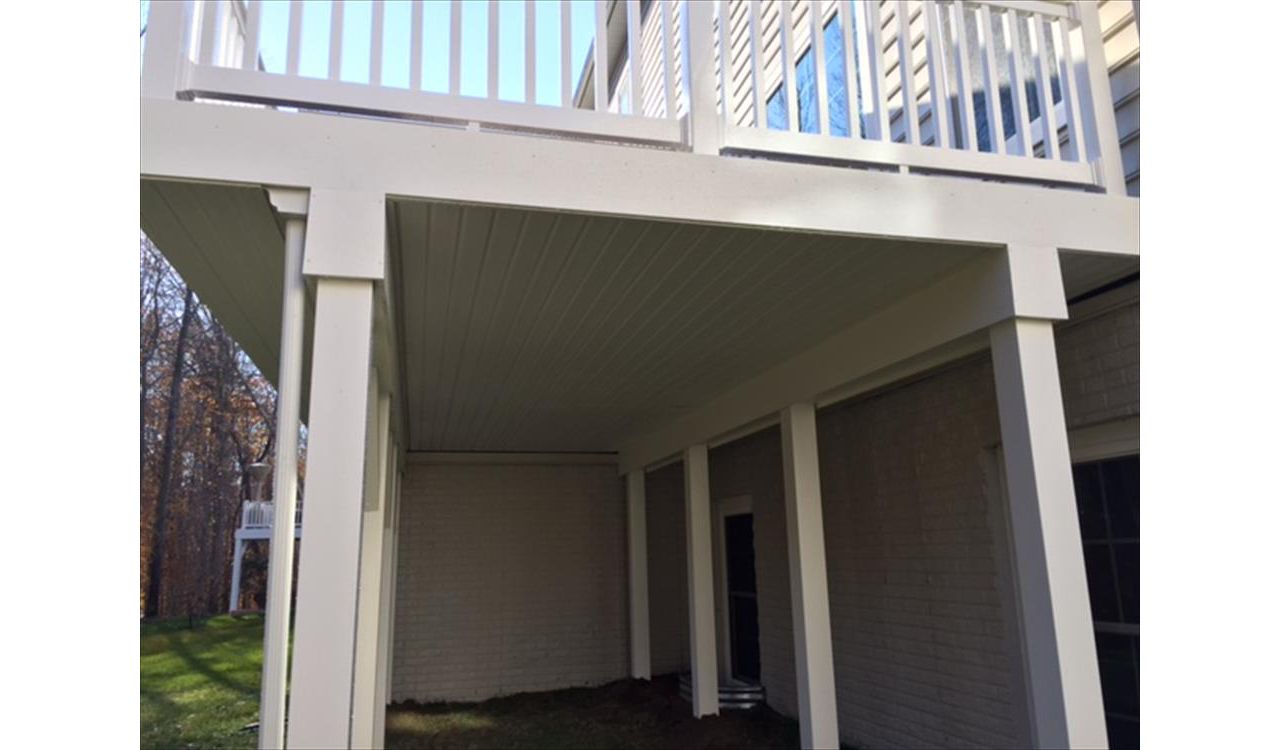 Trex RainEscape System with a closed off soffit ceiling and PVC wrapped posts and beams.