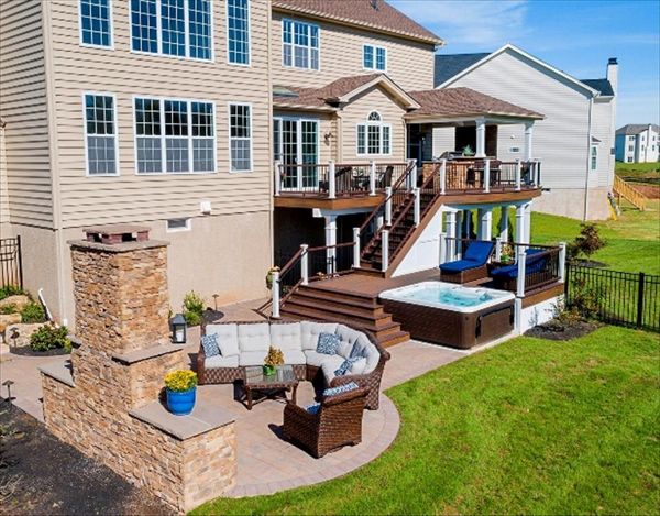 Trex Transcend Spiced Rum and Vintage Lantern deck with Custom roof, outdoor kitchen, patio and fireplace.