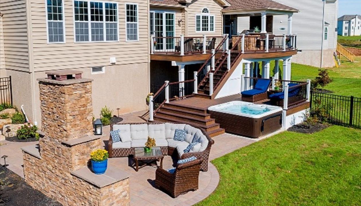 Trex Transcend Spiced Rum and Vintage Lantern deck with Custom roof, outdoor kitchen, patio and fireplace.