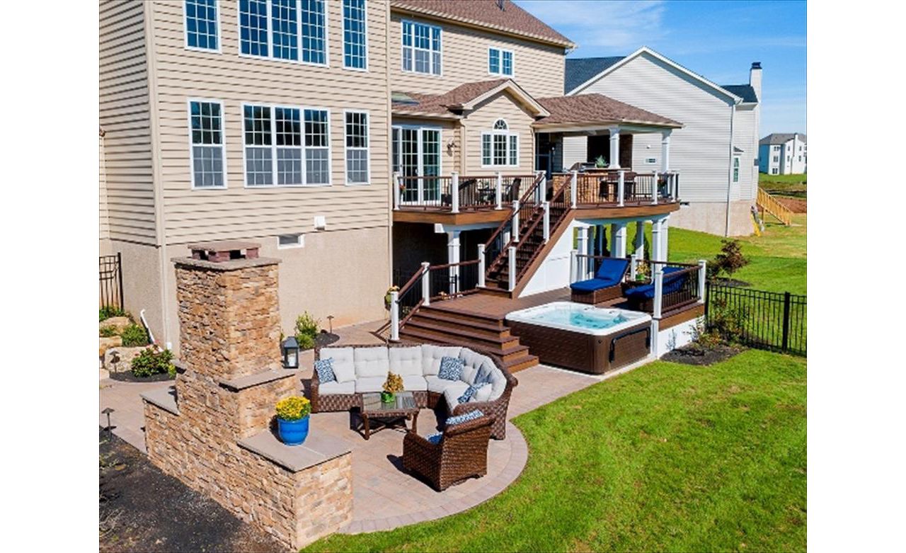 Trex Transcend Spiced Rum and Vintage Lantern deck with Custom roof, outdoor kitchen, patio and fireplace.