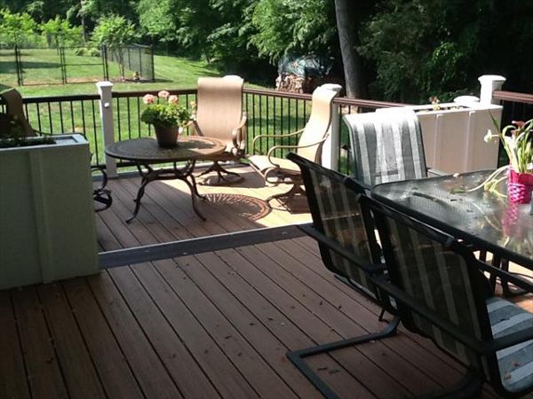 Trex Transcend Tiki Torch deck with Vintage Lantern picture frame & Trex Transcend handrails with Trex Elevations framing product in Clemmons, NC.