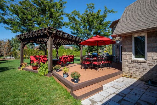 Brown composite decking using Transcend Tiki Torch with Vintage Lantern Trim and custome wood pergola - Orangeville, Caledon, Alliston, Bolton, Schomberg, Nobelton