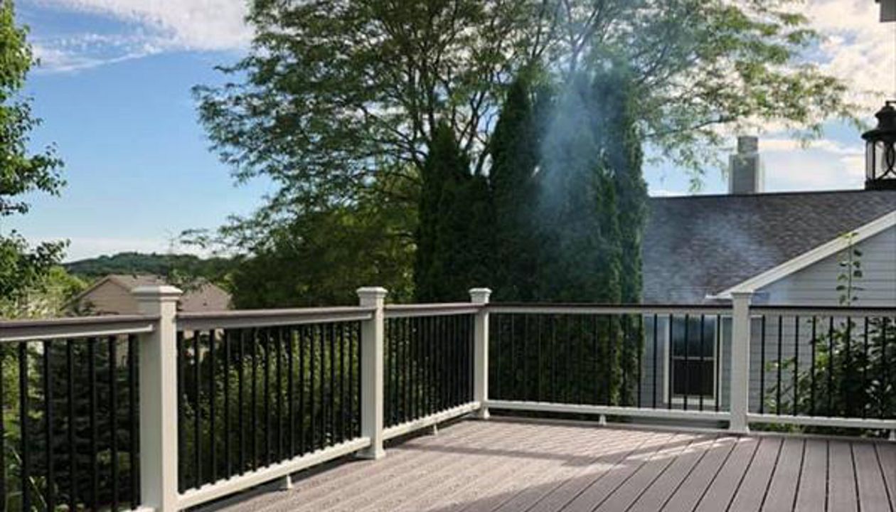 This deck consists of Trex select saddle decking and drink rail. The railing is Trex Transcend with white top bottom rail and round aluminum ballasters.
