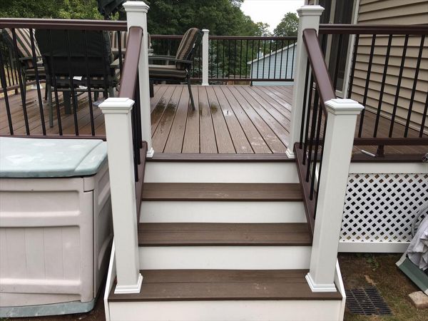 Trex Transcend project in Middletown, CT.  Spiced Rum field featuring a Vintage Lantern border.  - Railings are Trex Transend in Vintage Lantern with black aluminum balusters.