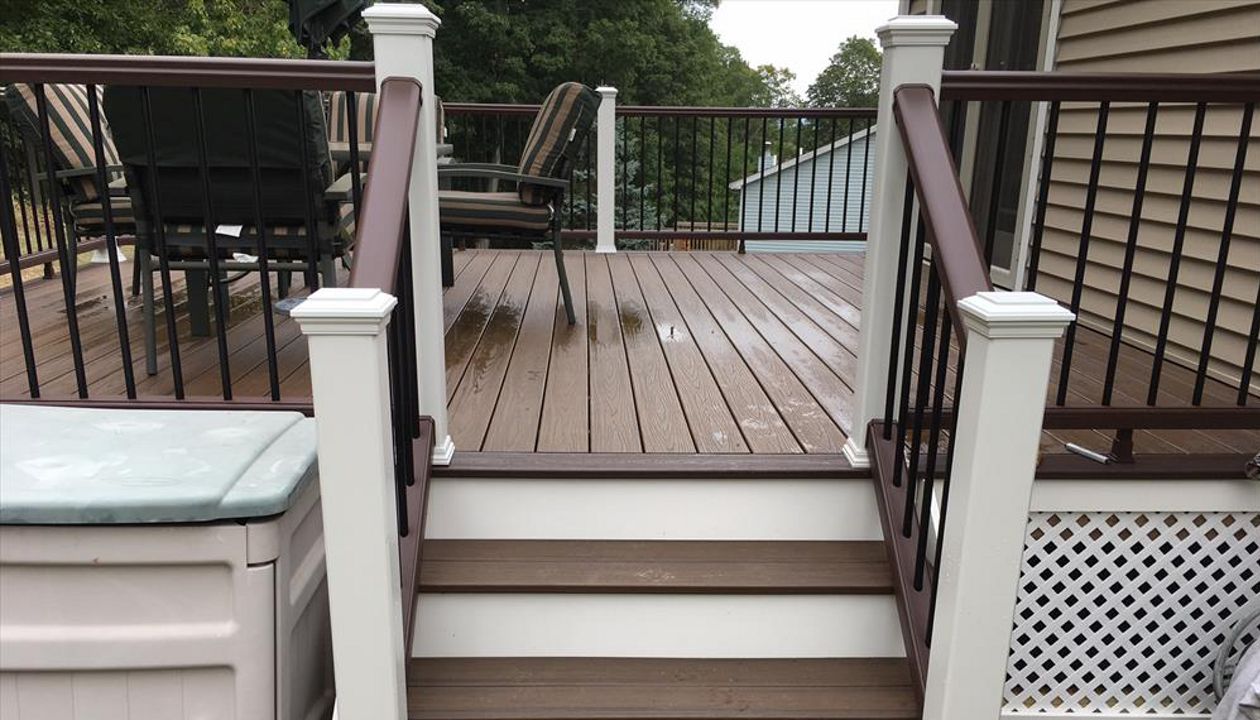 Trex Transcend project in Middletown, CT.  Spiced Rum field featuring a Vintage Lantern border.  - Railings are Trex Transend in Vintage Lantern with black aluminum balusters.