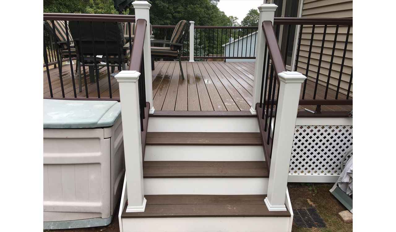 Trex Transcend project in Middletown, CT.  Spiced Rum field featuring a Vintage Lantern border.  - Railings are Trex Transend in Vintage Lantern with black aluminum balusters.