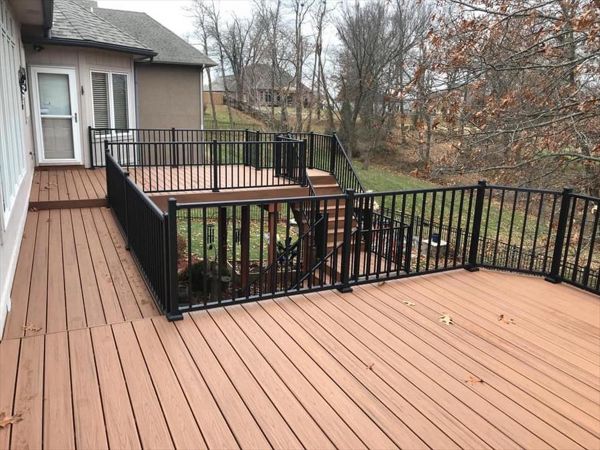 Composite deck in Warrensburg Missouri. The color of the deck is a bold tropical color called Tiki Torch.