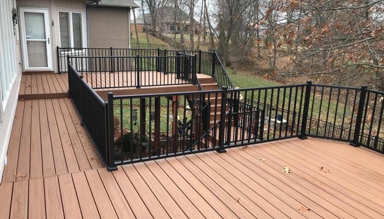 Composite deck in Warrensburg Missouri. The color of the deck is a bold tropical color called Tiki Torch.