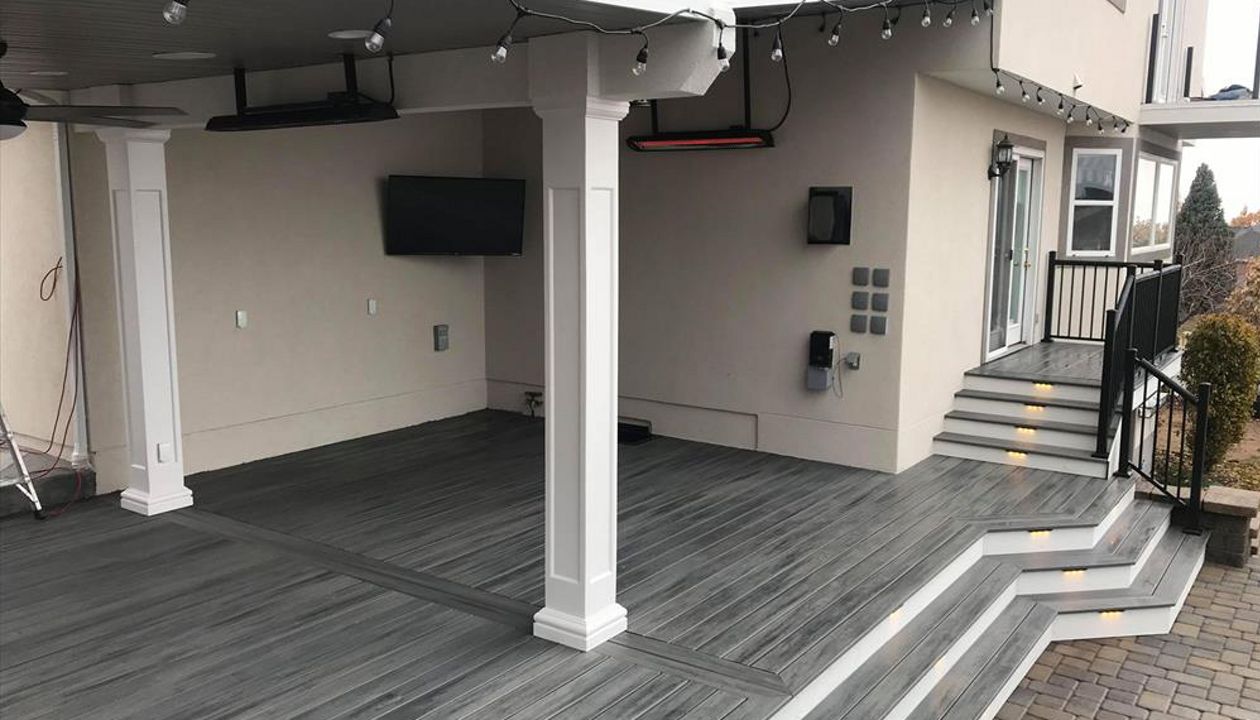 island mist with white trex fascia, deck lighting, roof build with ceiling fans, drop heaters and tv