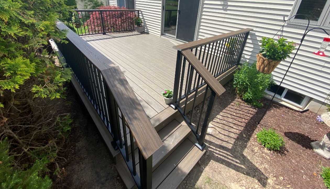 Overhead Enhanced Naturals - Coastal Bluff decking, picture frame and fascia with a Transcends - Spiced Rum drink rail