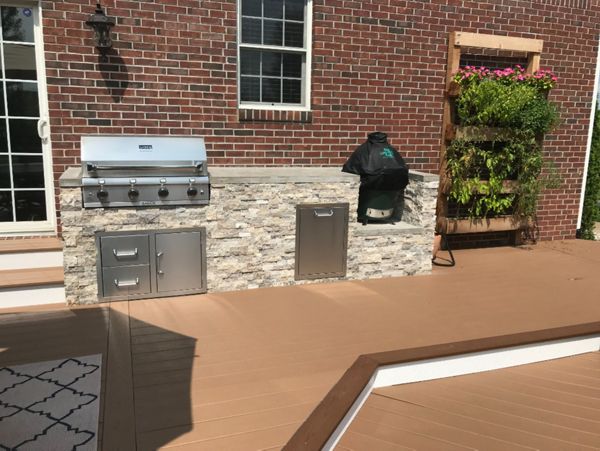 Trex Deck (Beach Dune) with Bullnose Border (Saddle) and Parting Board (Beach Dune). Outdoor Kitchen with Faux stone Façade and Concrete Top.