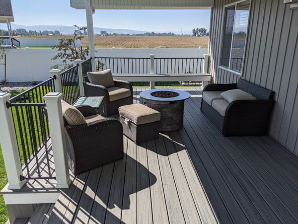 Island Mist Decking and Skirting, Black Iron Metal Rail and white Trex Posts.