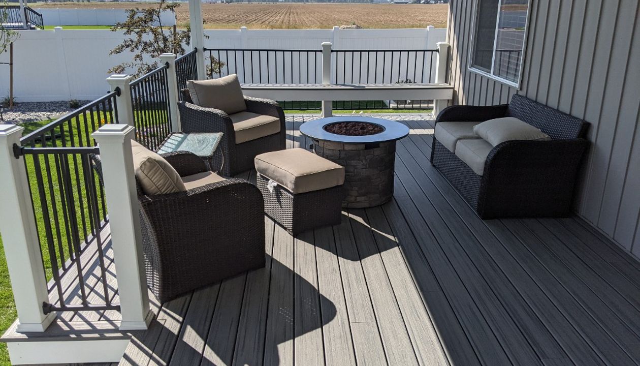 Island Mist Decking and Skirting, Black Iron Metal Rail and white Trex Posts.