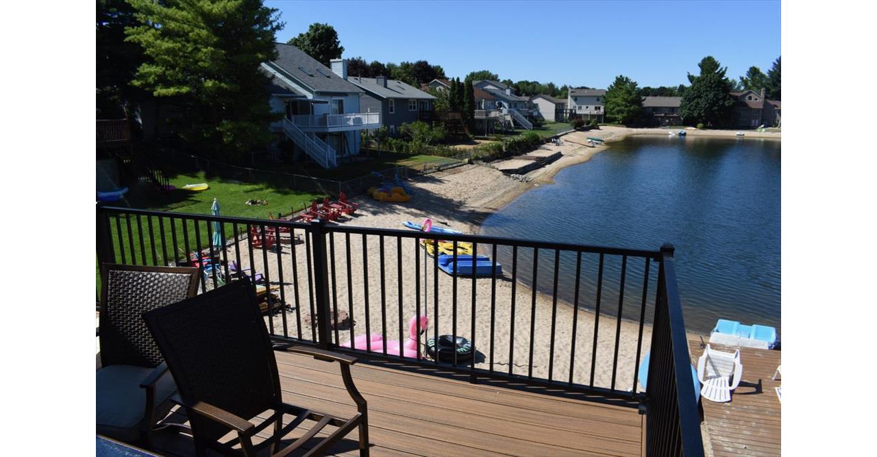Waterfront custom designed Trex deck. Serving Grandville, Wyoming, Grand Rapids, Forrest Hills, Rockford, and surrounding areas.