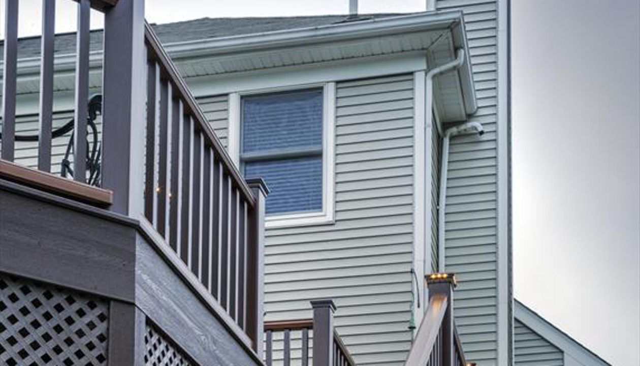 Trex riser lights and pyramid post cap lights elegantly guide you up the stairs to this Clinton, N.J. deck getaway.