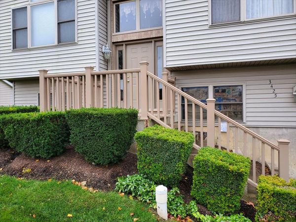 Transcend Railing in Ropeswing replaced an old wooded guardrail and staircase railing in McHenry, IL.  Use of Trex structural mounting post secure the guard rails to the concrete front stoop and steps.