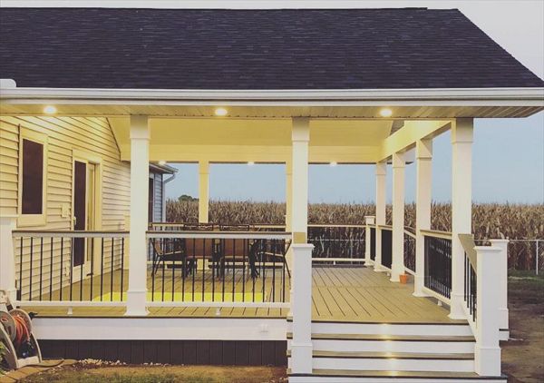 Side shot of a porch addition with soffit and stair lighting.